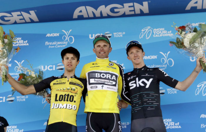 Stage 2 winner Rafal Majka, center, of Poland, poses for pictures on the podium with second place finisher George Bennett, left, of New Zealand, and third place finisher Ian Boswell during the Tour of California cycling race on Monday in San Jose, Calif. — AP