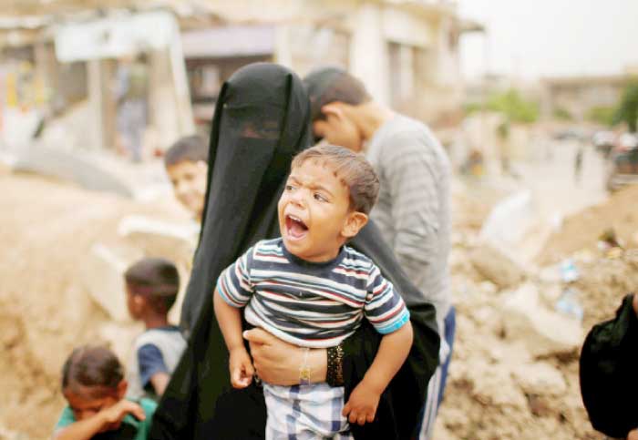 A boy cries as displaced Iraqis flee their homes while Iraqi forces battle Daesh militants in western Mosul. — Reuters