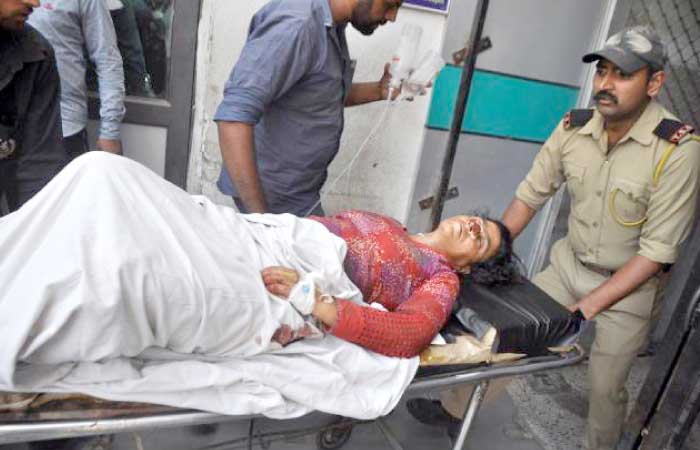 Indian medical and security officials use a trolley as they transfer injured villager Zatoon Bi into the Government Medical College Hospital in Jammu on Saturday, after she was injured in mortar shelling from across the Line of Control in Jhangar area of Rajouri district. — AFP
