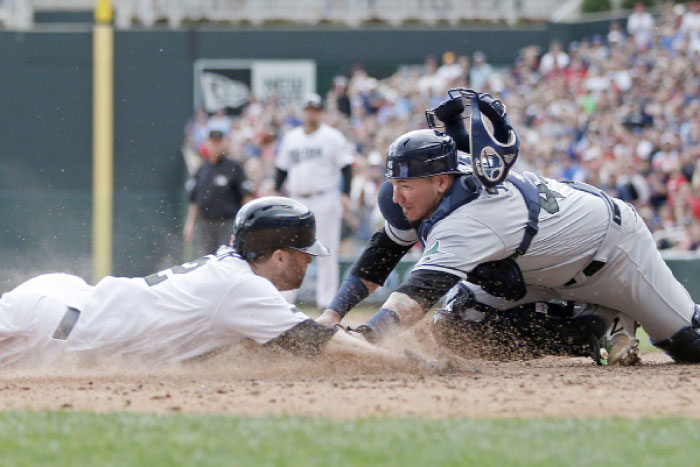 Minnesota Twins' Brian Dozier is tagged out by trying to score by Tampa Bay Rays catcher Jesus Sucre as he tried to score on a Joe Mauer hit in the eighth inning of a baseball game Sunday in Minneapolis. The Rays won 8-6 in 15 innings. — AP