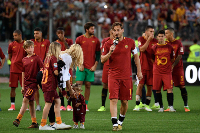 AS Roma's captain Francesco Totti delivers a speech next to his wife Ilary and his children during a ceremony following his last match with AS Roma after the Italian Serie A football match between Roma and Genoa on Sunday. — AFP