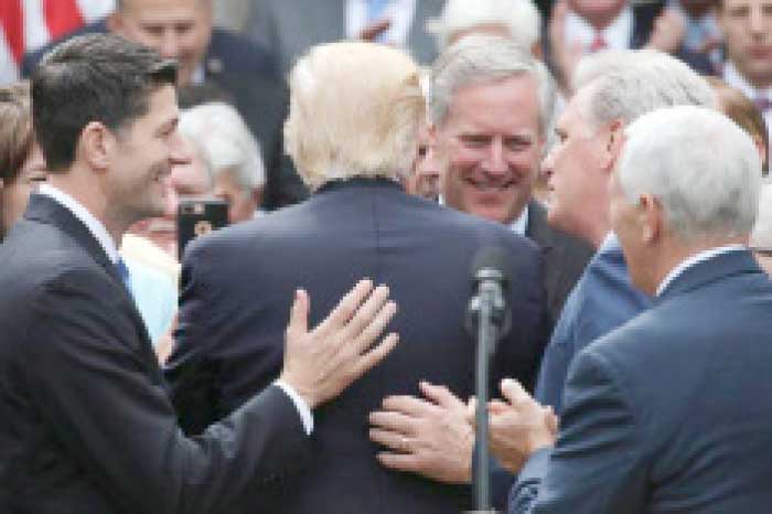 US President Donald Trump, second left, is surrounded Speaker of the House Paul Ryan, left, and House Freedom Caucus Chairman Mark Meadows, third right, House Majority Leader Kevin McCarthy, second right, and Vice President Mike Pence after the House of Representatives approved the American Healthcare Act, to repeal major parts of Obamacare and replace it with the Republican healthcare plan, in Washington,in this May 4, 2017 file photo. — Reuters