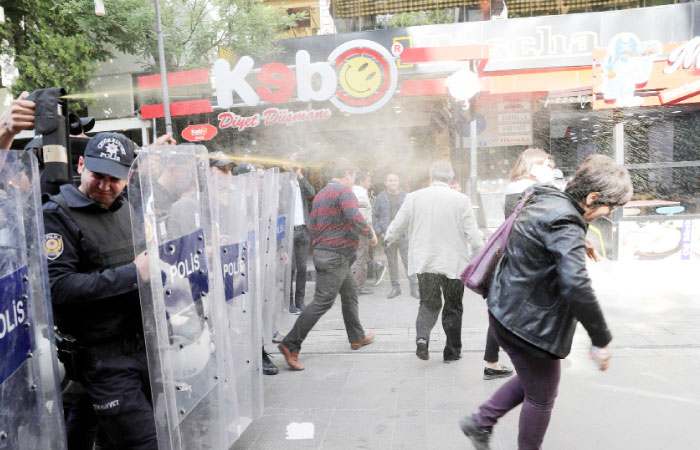 Turkish riot policemen use tear gas to disperse protesters during a demonstration against the arrest of hunger strikers Nuriye Gulmen and Semih Ozakca in Ankara. — AFP