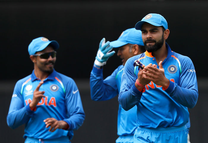 India's captain Virat Kohli (R) applauds as he leaves the pitch with his team after bowling out South Africa for 191 during their ICC Champions Trophy match at The Oval in London Sunday. — AP