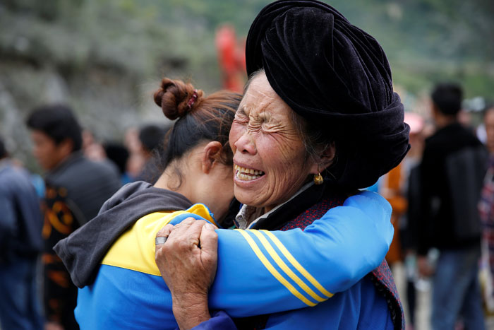 Relatives of victims react at the site of a landslide in the village of Xinmo, Mao County, Sichuan Province, China on Monday. — Reuters