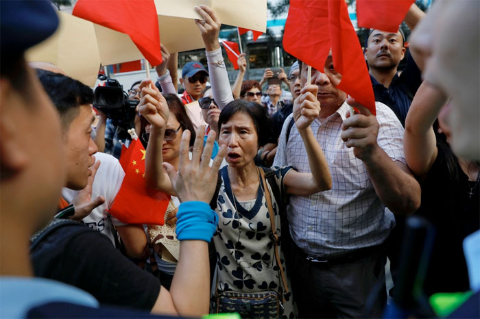 Police divides pro-China and pro-democracy protesters facing each other in central Hong Kong, China as the city marks the 20th anniversary of the city's handover from British to Chinese rule, Friday. — Reuters