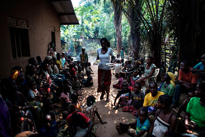 This file photo taken in Kikwit shows a volunteer bringing daily food rations for Internally Displaced Persons (IDP's), at a camp for IDP's fleeing the conflict in the Kasai region. — AFP