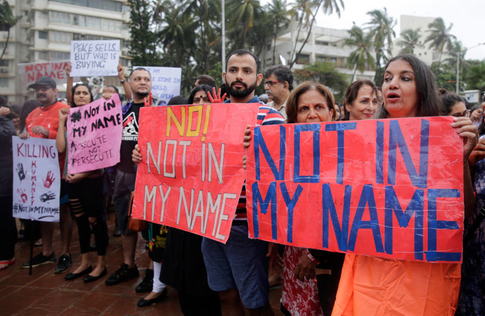 Bollywood actress Shabana Azmi, right, joins others to protest against a spate of violent attacks across the country targeting the country's Muslim minority, in Mumbai, India, Wednesday. Carrying placards that said 