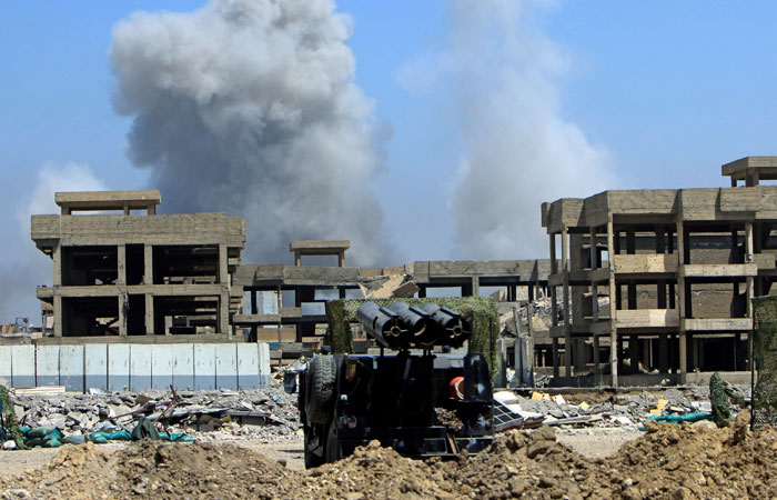 Smoke rises from clashes in the Old City of Mosul, Iraq, on Tuesday. — Reuters