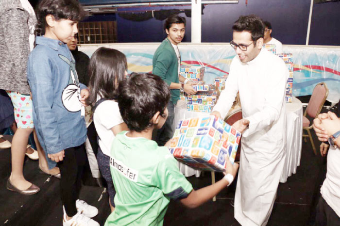 Volunteers host orphans at an iftar in a theme park. — SG photo