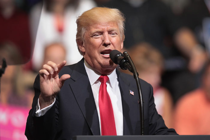 President Donald Trump speaks at a recent rally in Cedar Rapids, Iowa. Trump spoke about renegotiating NAFTA and building a border wall that would produce solar power during the rally. — AFP