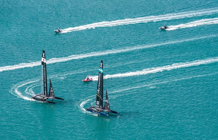 SoftBank Team Japan, left, and Artemis Racing compete in America's Cup challenger semifinals on the Great Sound in Bermuda on Monday. — AP