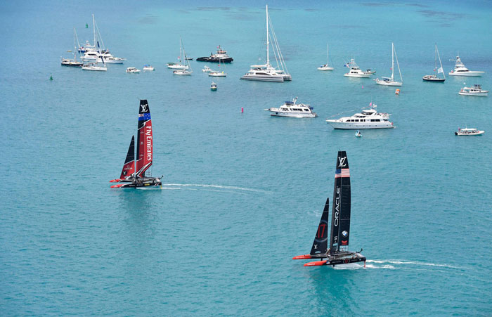 Emirates Team New Zealand (L) competes against two-time defending champion Oracle Team USA in Race 1 of the America's Cup in Bermuda Saturday. — AP