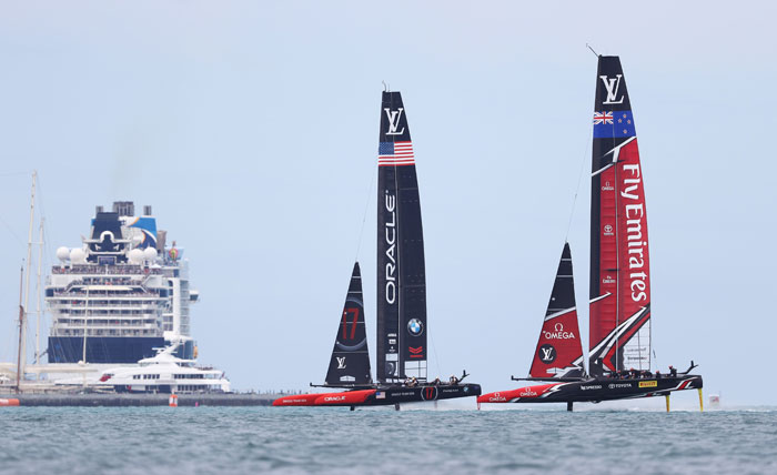 Emirates Team New Zealand, helmed by Peter Burling, competes with Oracle Team USA, skippered by Jimmy Spithill, during Day 3 of the America's Cup in Hamilton, Bermuda, Saturday. — AFP
