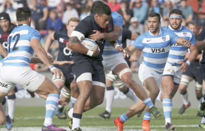 England’s Nathan Hughes (2nd L) is tackled by Argentina’s Nicolas Sanchez during a rugby test match against Argentina in Santa Fe, Argentina, Saturday. — AP