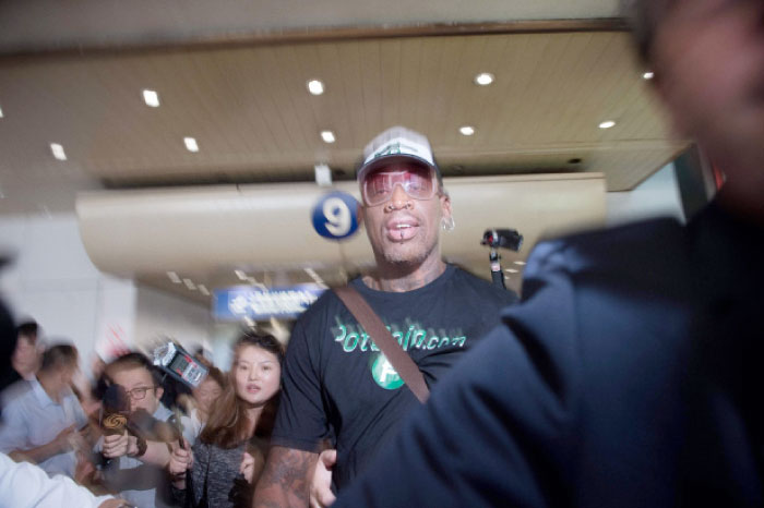 Former NBA player Dennis Rodman (C) of the US walks out from the arrival gate returning from his trip to North Korea at Beijing’s International Airport Saturday. — AFP
