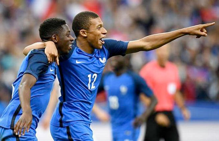 France’s Ousmane Dembele (left) celebrates with Kylian Mbappe after a win in Paris on Tuesday. — AFP