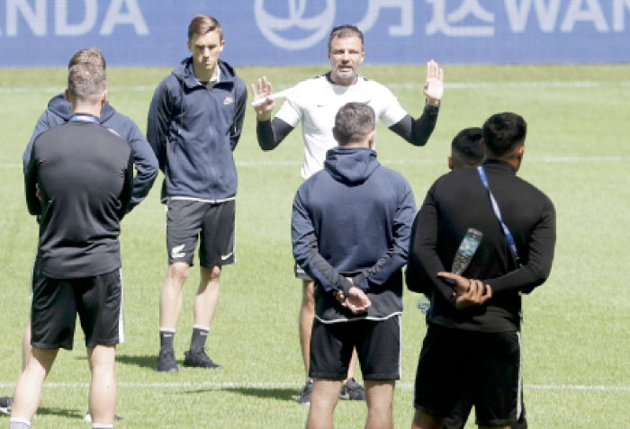 New Zealand coach Anthony Hudson talks to his players prior to a training session at the St. Petersburg Stadium, Russia, Friday. — AP