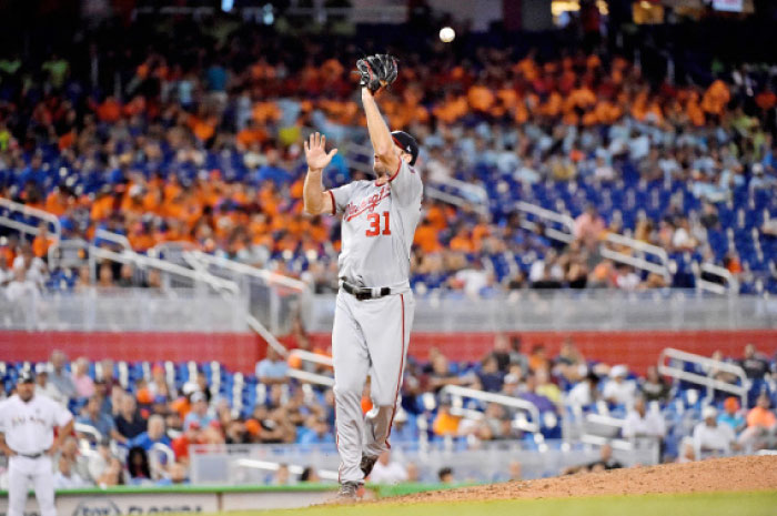 Washington Nationals’ starting pitcher Max Scherzer fails to come up with the ball on a hit by Miami Marlins’ catcher A.J. Ellis during their MLB game at Marlins Park in Miami Wednesday. — Reuters