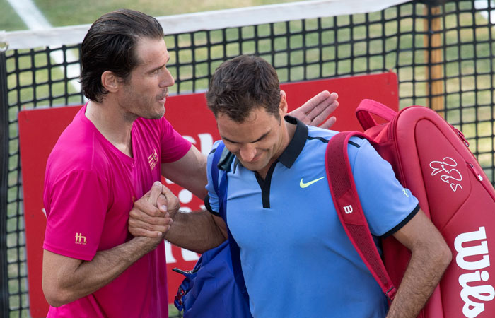 Switzerland's Roger Federer (R) is comforted by Germany's Tommy Haas after he lost in their round of 16 match at the ATP Cup Tennis Tournament in Stuttgart Wednesday. — AFP