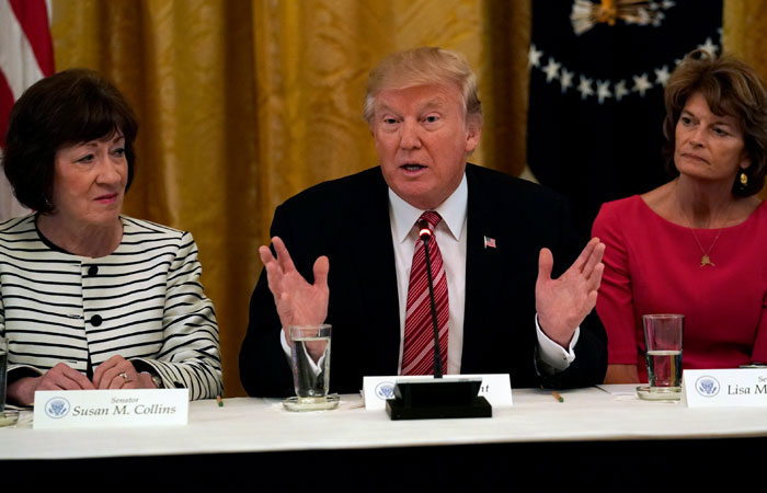 US President Donald Trump meets with Senate Republicans about healthcare in the East Room of the White House in Washington, US, Tuesday. Trump is flanked by Senators Susan Collins, L, (R-ME) and Sen. Lisa Murkowski, R, (R-AK). — Reuters