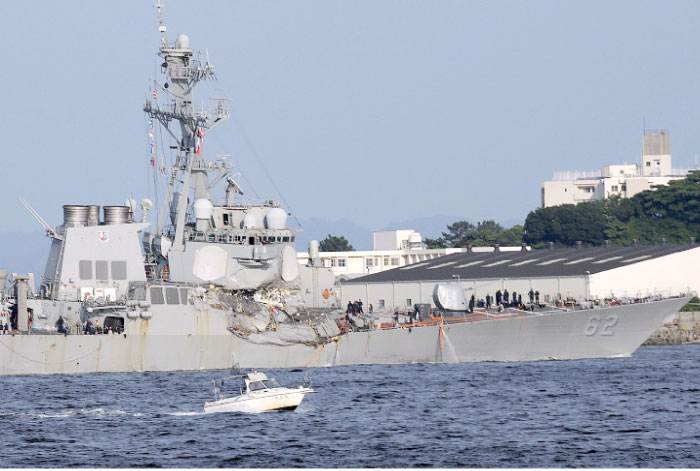 The damaged USS Fitzgerald is seen near the US Naval base in Yokosuka, southwest of Tokyo, after the US destroyer collided with the Philippine-registered container ship ACX Crystal in the waters off the Izu Peninsula on Saturday. — AP