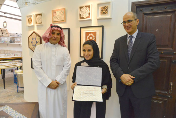 One of the participants in the first annual exhibition at the Jameel House of Traditional Arts in Jeddah receiving the certificate.