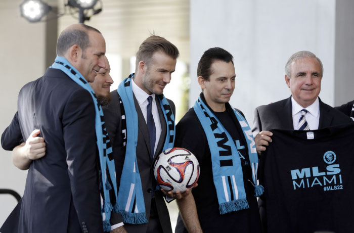 In this Feb. 5, 2014, file photo, former English soccer star David Beckham (3rd L) poses with MLS Commissioner Don Garber (L) Miami-Dade County mayor Carlos Gimenez (R) and soccer fans with the Southern Legion at a news conference where he announced he will exercise his option to purchase a Major League Soccer expansion team, in Miami. — AP