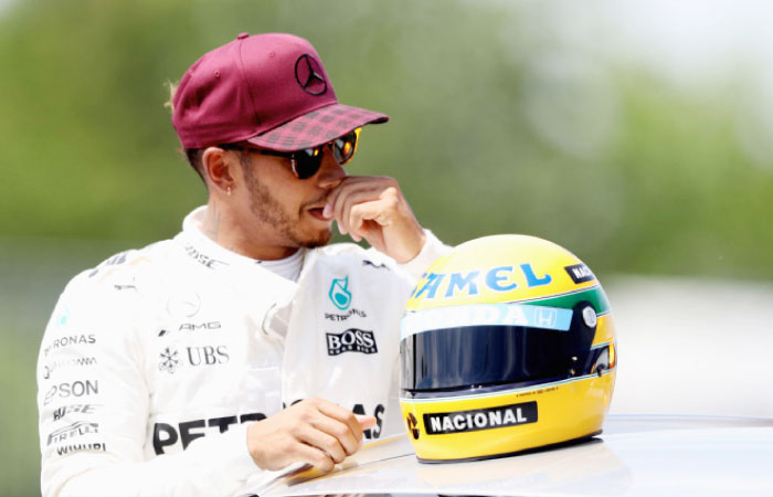 Lewis Hamilton with a commemorative helmet of F1 legend Ayrton Senna after he beat the previous record of 65 pole positions during qualifying for the Canadian Formula One Grand Prix at Circuit Gilles Villeneuve on June 10, 2017 in Montreal, Canada. — AFP