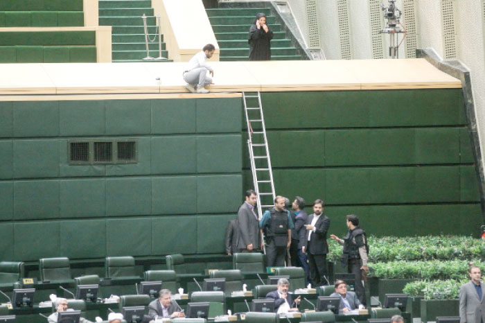 Policemen deploying in the main hall of Iranian parliament to protect lawmakers during the attack which targeted the complex Wednesday. — AFP