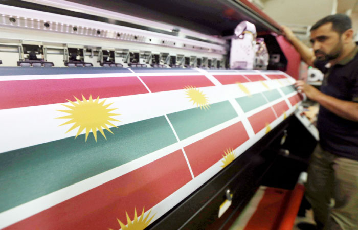 An Iraqi man prints a flag of Kurdistan in Irbil, the capital of the autonomous Kurdish region of northern Iraq. Iraq’s autonomous Kurdish region will hold a historic referendum on statehood in September, despite opposition to independence from Baghdad and possibly beyond. — AFP