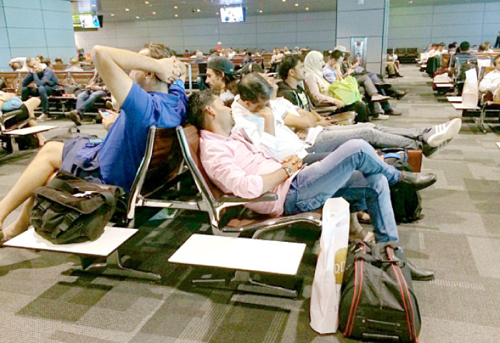 Passengers of canceled flights wait in Hamad International Airport (HIA) in Doha, Qatar, Tuesday. — AP