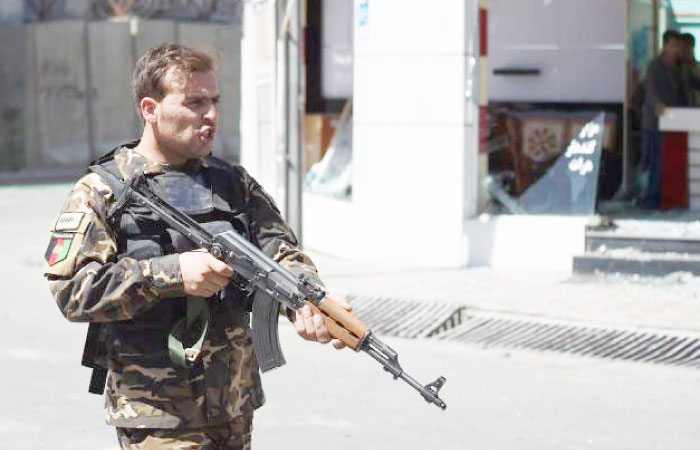 An Afghan security personnel dtands guard near the site of a truck bomb attack in Kabul in this May 31, 2017 file photo. — AFP