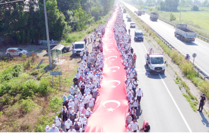 Thousands of supporters hold a 1 100 meters-long national flag as they follow Kemal Kilicdaroglu, the leader of Turkey’s main opposition Republican People’s Party, on the 17th day of his 425-kilometer (265-mile) march in Sakarya, some 220 kilometers from the capital Ankara. — AFP
