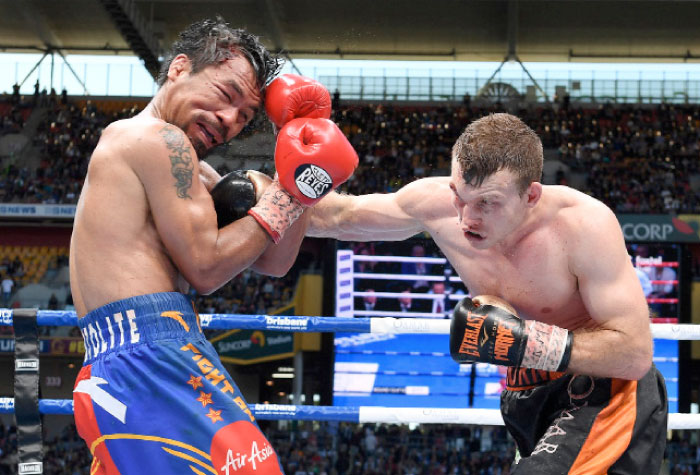 Jeff Horn (R) of Australia punches Manny Pacquiao of the Philippines during their bout in Brisbane Sunday. — Reuters