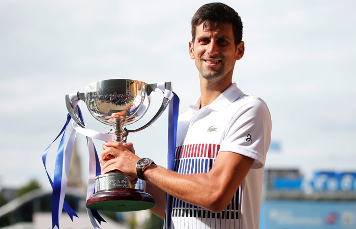 Serbia's Novak Djokovic celebrates with the trophy after winning the final against France's Gael Monfils at the Aegon International in Eastbourne Saturday. —Reuters